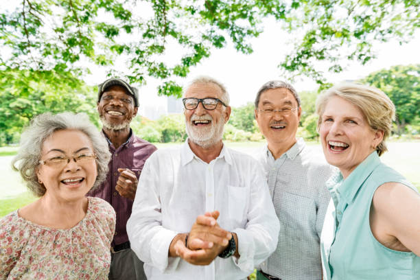 Smiling group of senior friends in park medical care